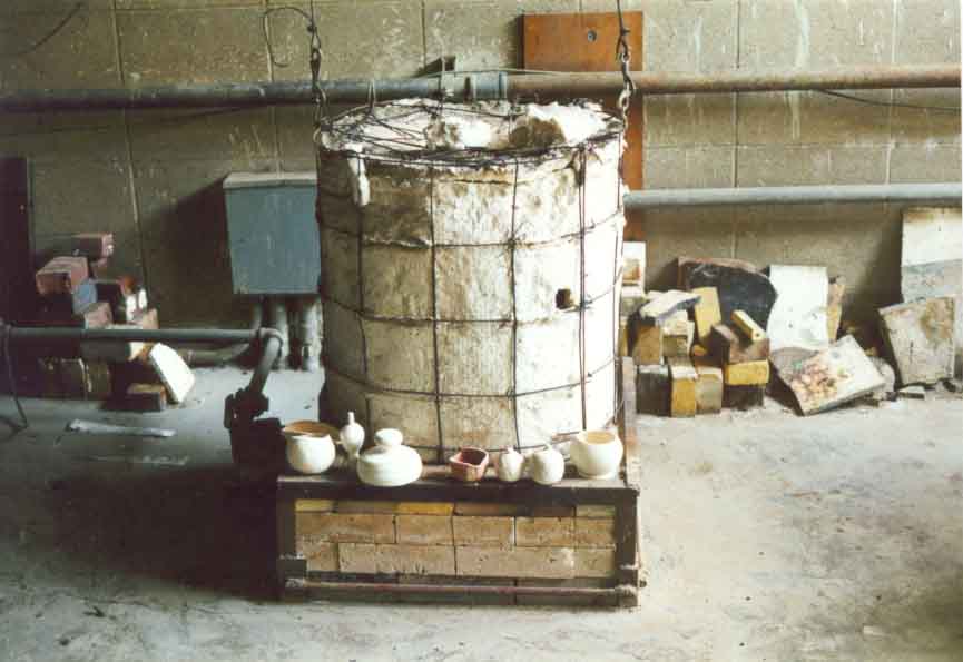 A Raku kiln surrounded by glazed bisque ware waiting to be fired