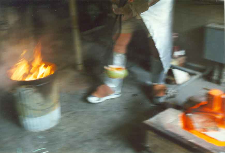 Ceramic tongs are used to remove fired pottery from the kiln to the reduction chamber